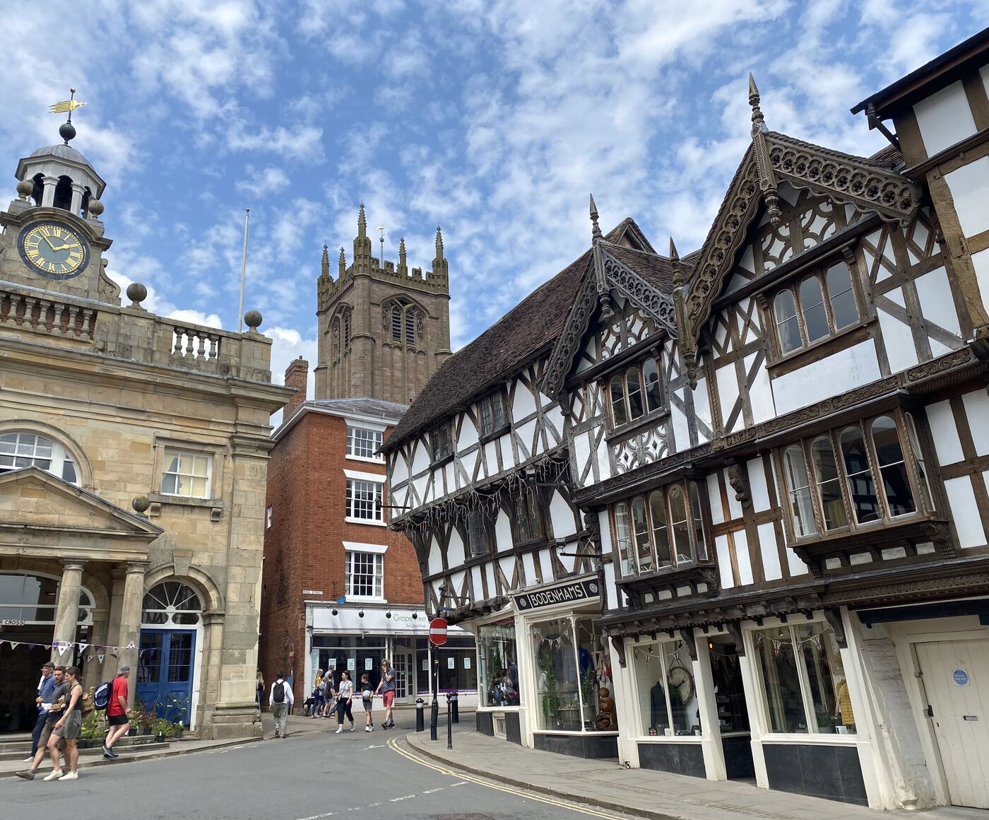 Timber-framed and Georgian buildings in the centre of Ludlow, the church tower beyond
